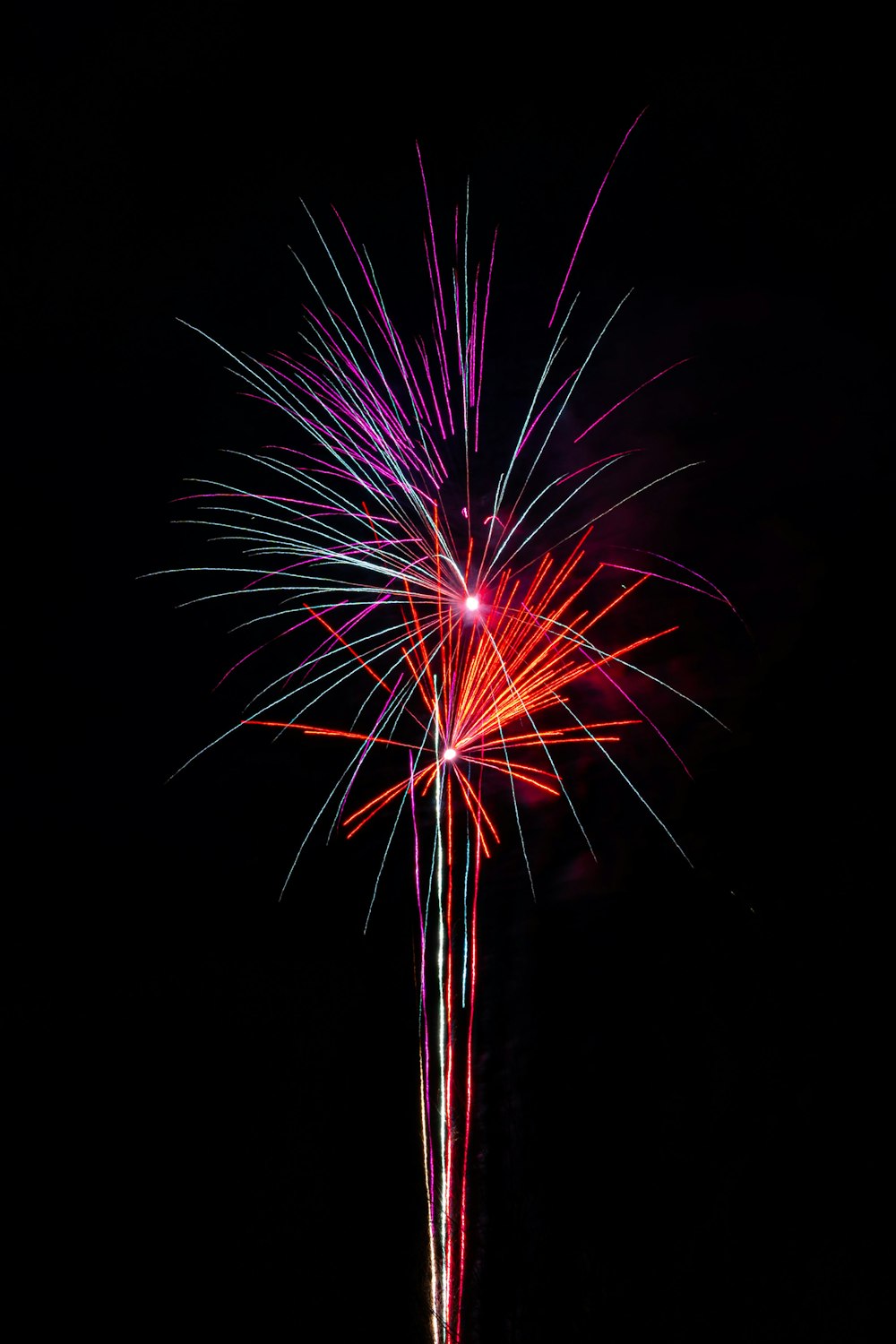 a colorful fireworks display in the dark sky