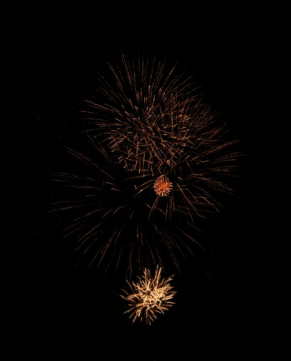 a firework is lit up in the dark sky