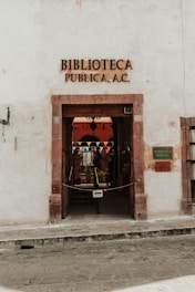 a white building with a sign that says bibliotea publicaa ac