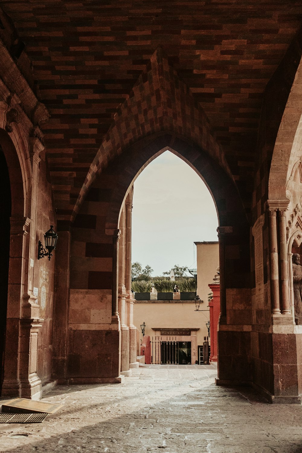 an archway in a building with a clock on the wall