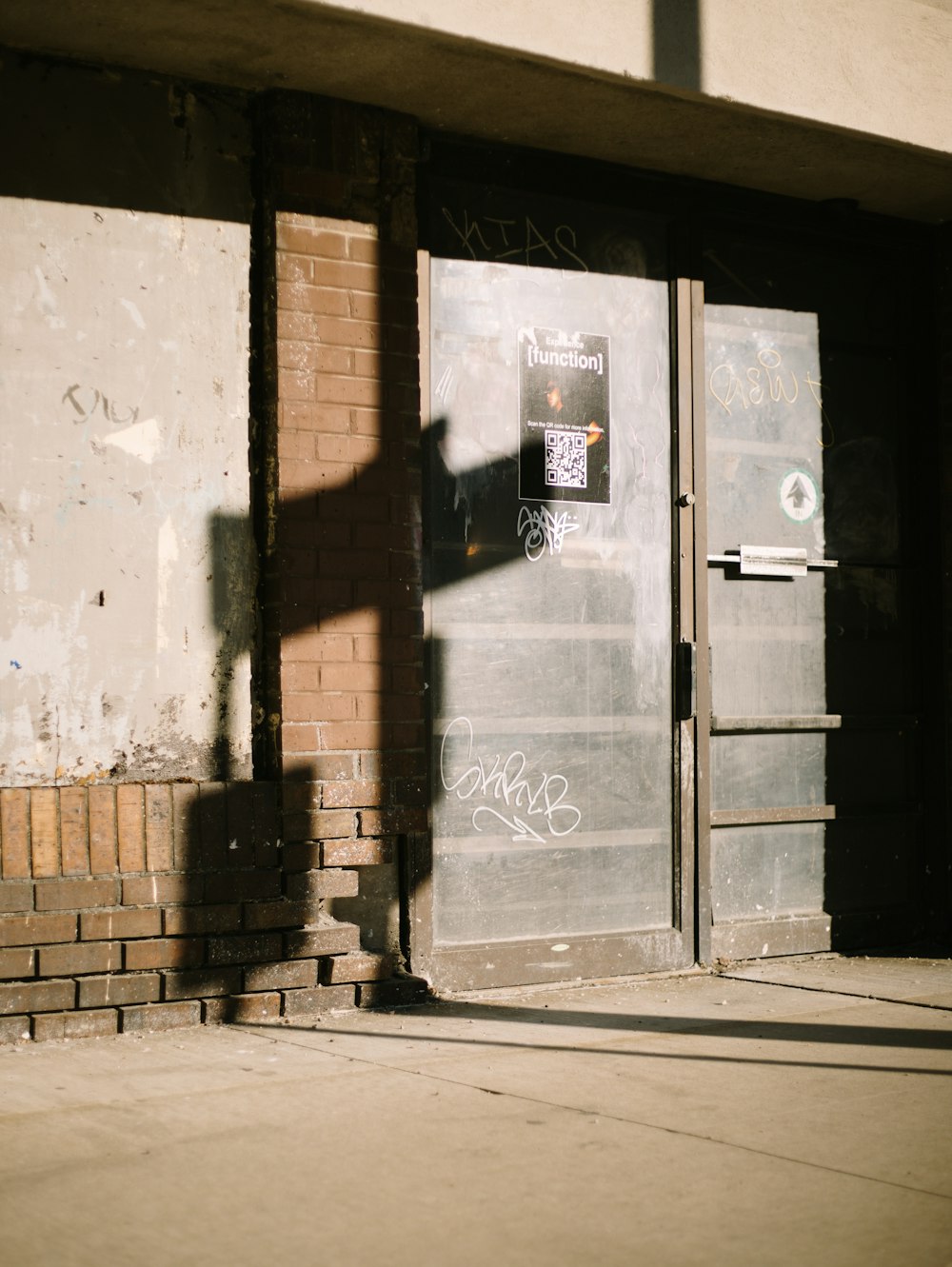 a door that has graffiti on it in front of a building