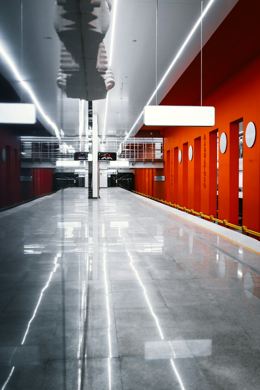 a long hallway with red and white walls