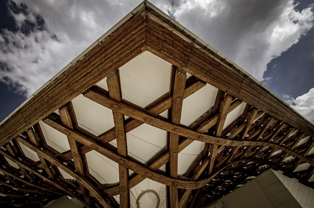 a wooden structure under a cloudy blue sky