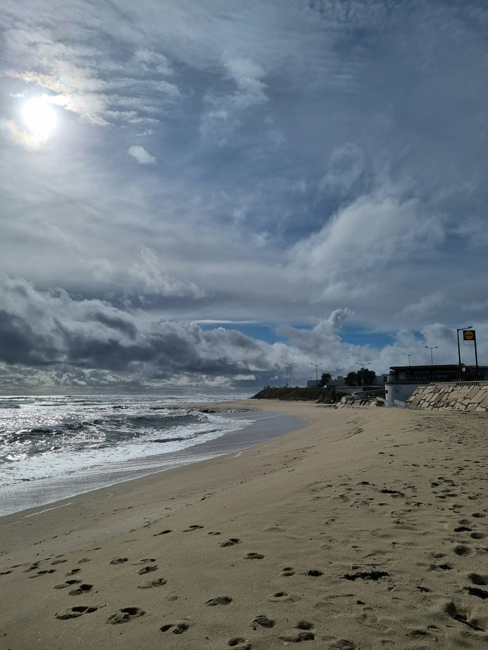 a sandy beach with footprints in the sand