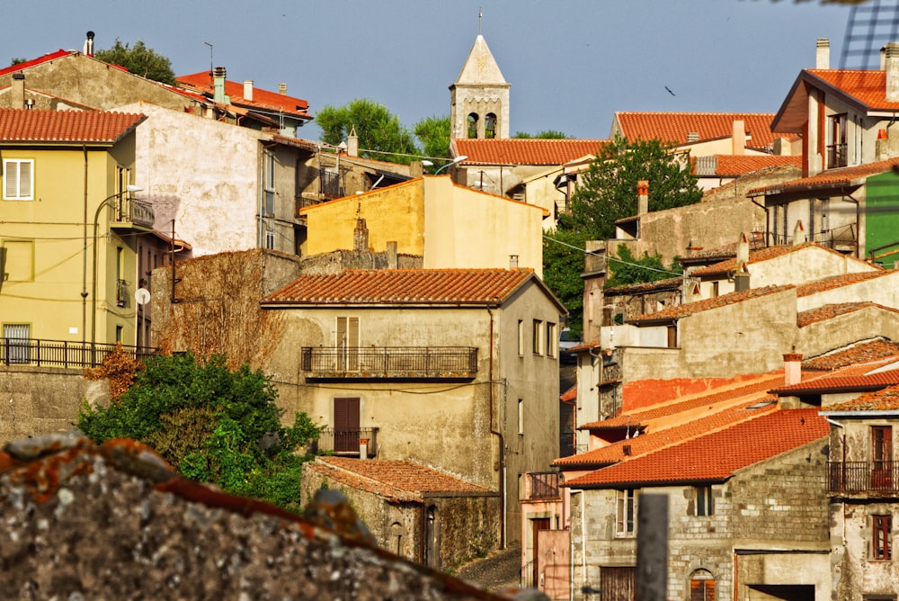 a group of buildings with a clock tower in the background