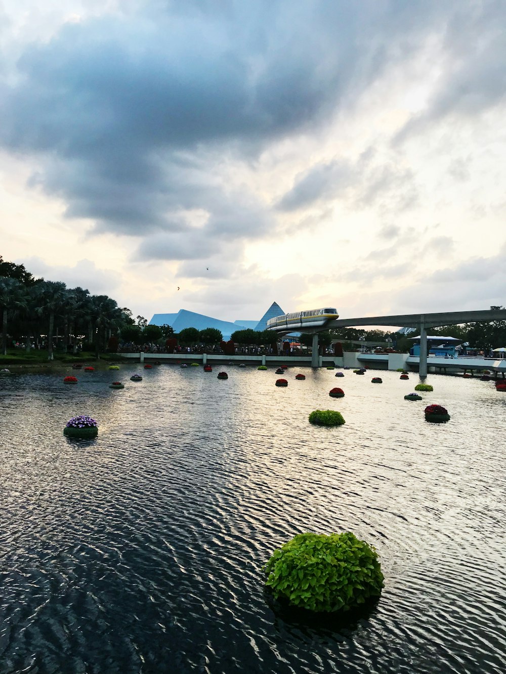 a body of water with a bridge in the background