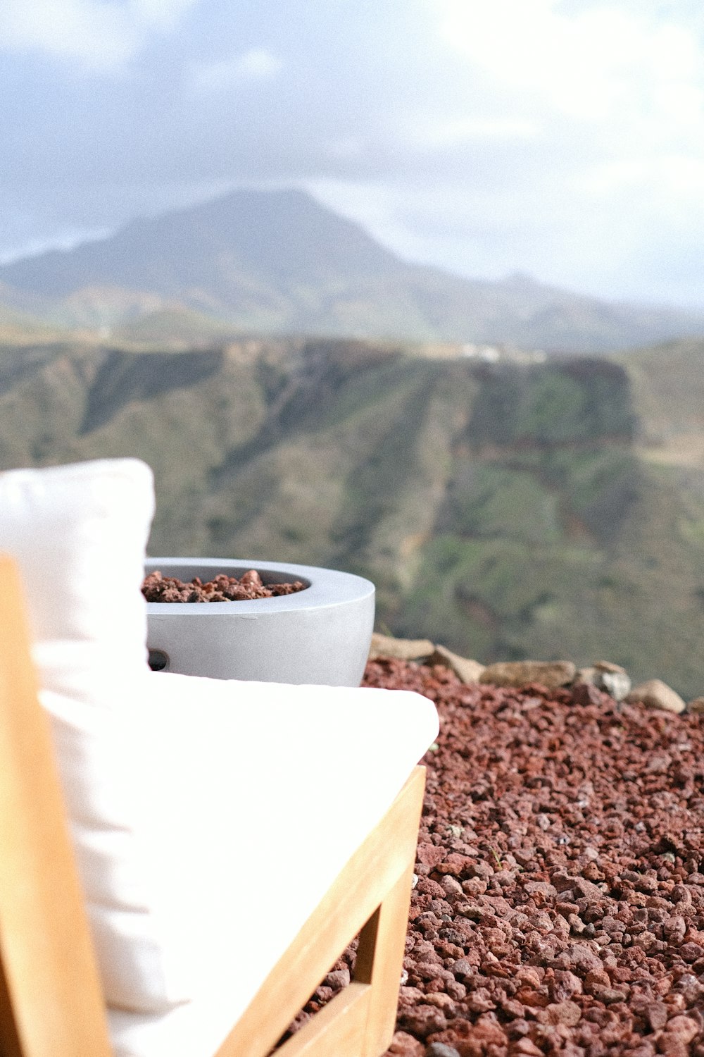 a chair sitting on top of a rocky hillside