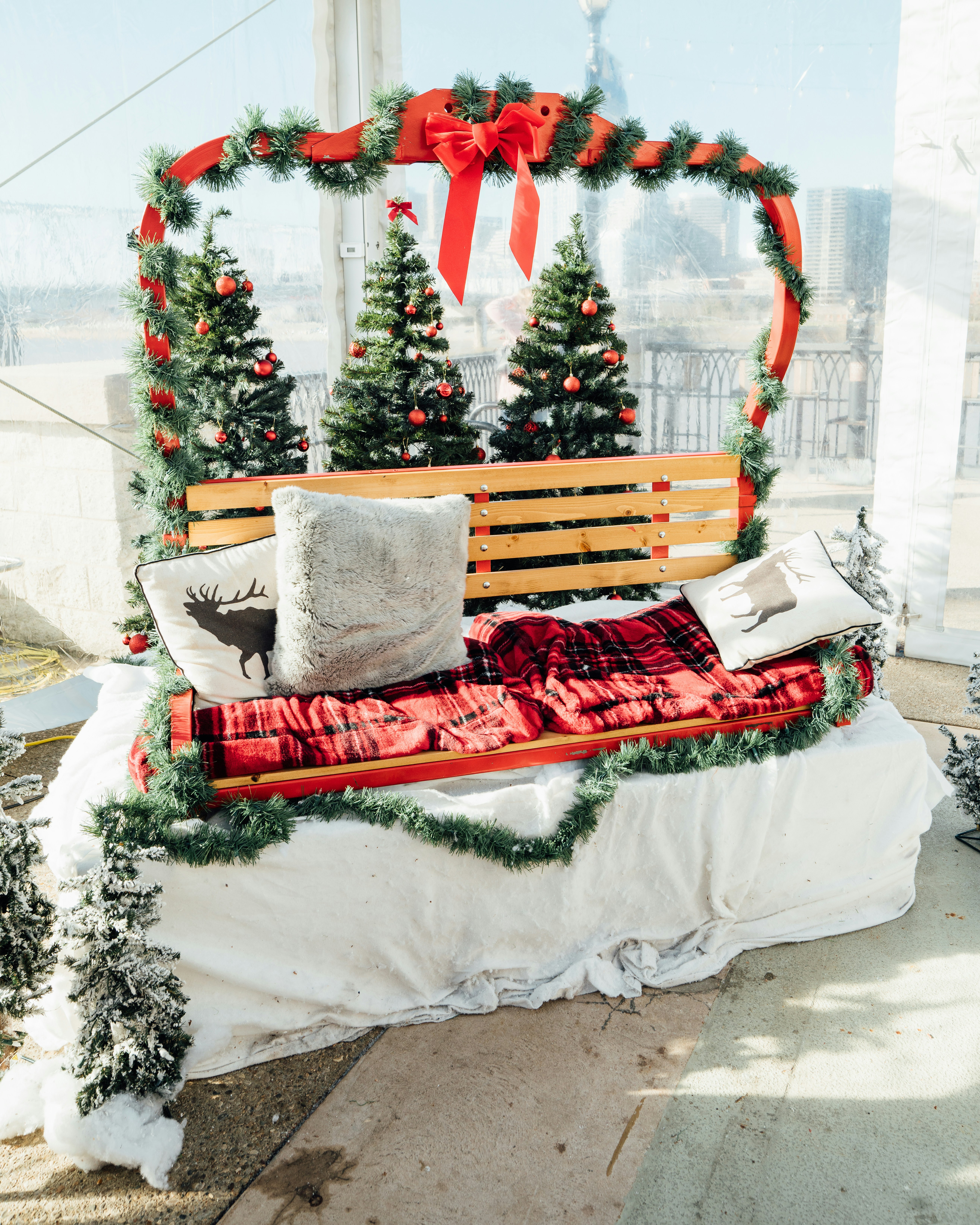 a wooden bench with christmas decorations on it
