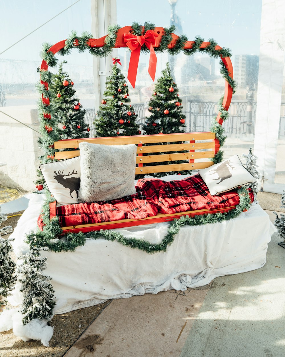 a wooden bench with christmas decorations on it