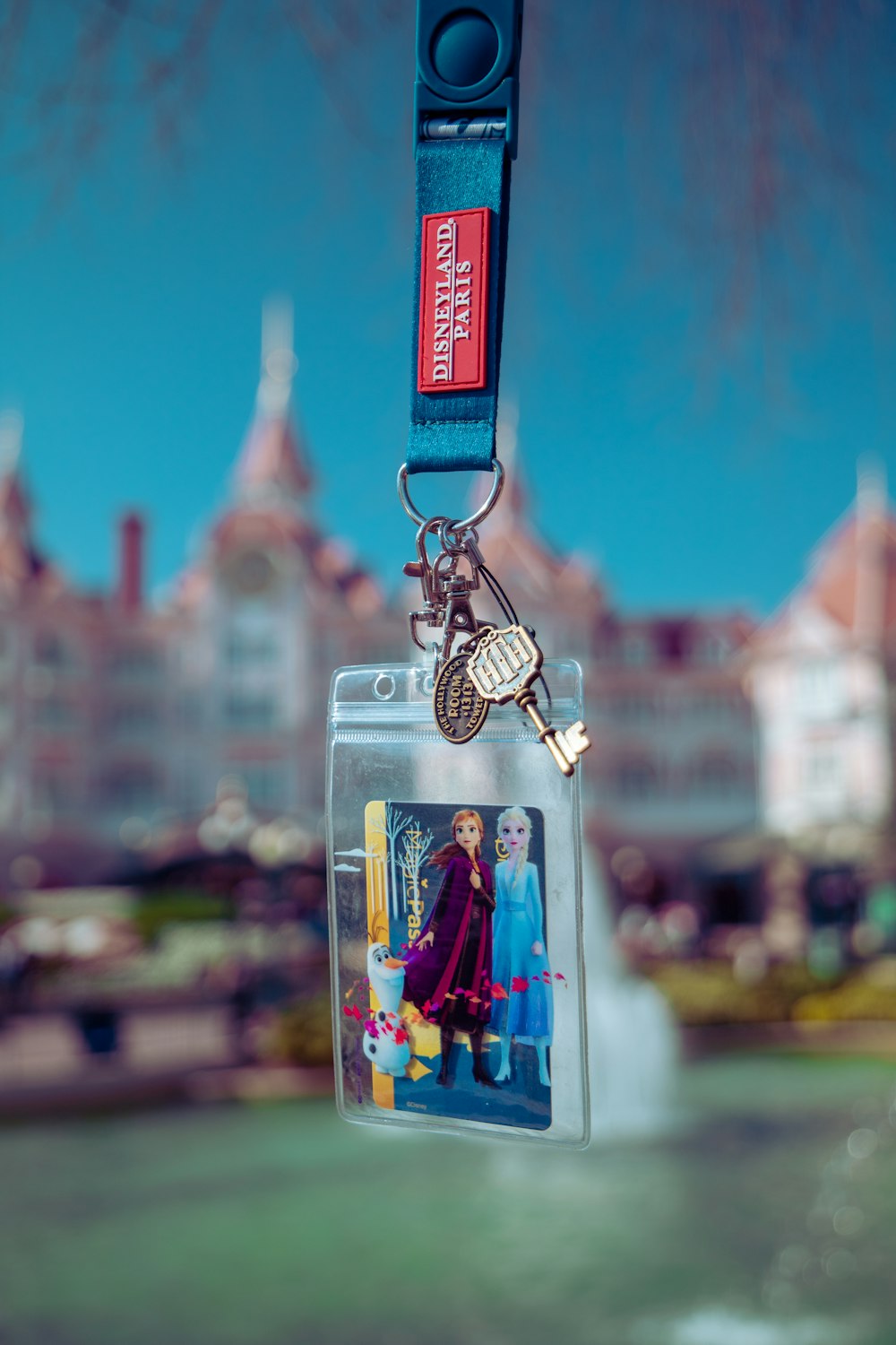 a keychain with a picture of a woman holding a tennis racquet
