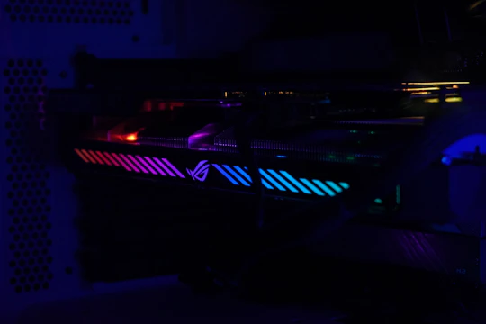 Close-up of a quantum processor chip illuminated with vibrant blue and purple lights.