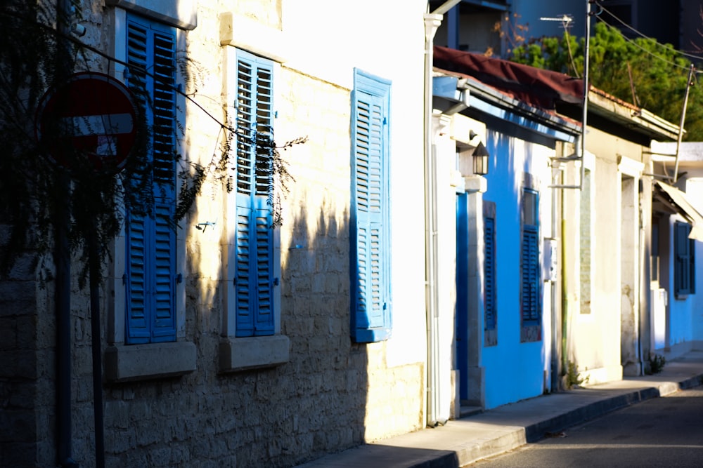 a row of buildings with blue shutters on the windows