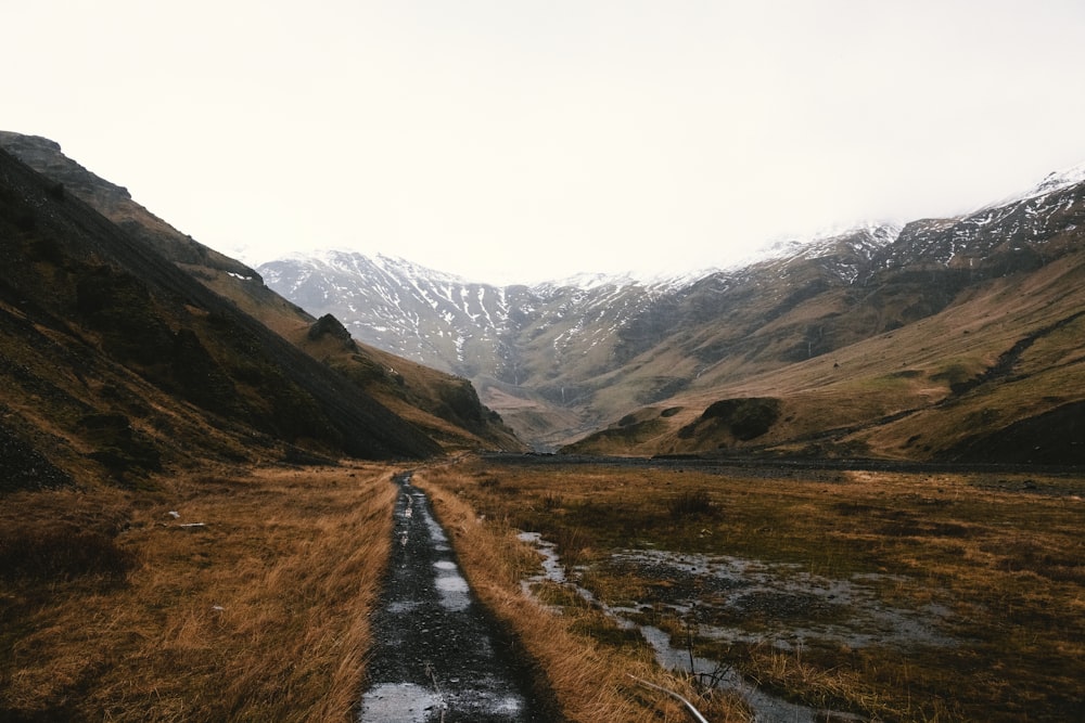 a dirt road in the middle of a mountain range