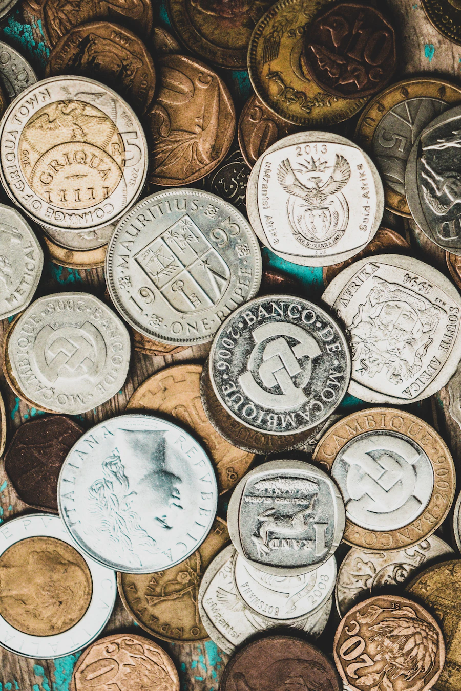 World coin collection on an aged wooden surface