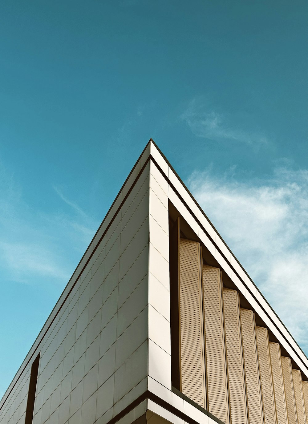 a tall building with a blue sky in the background