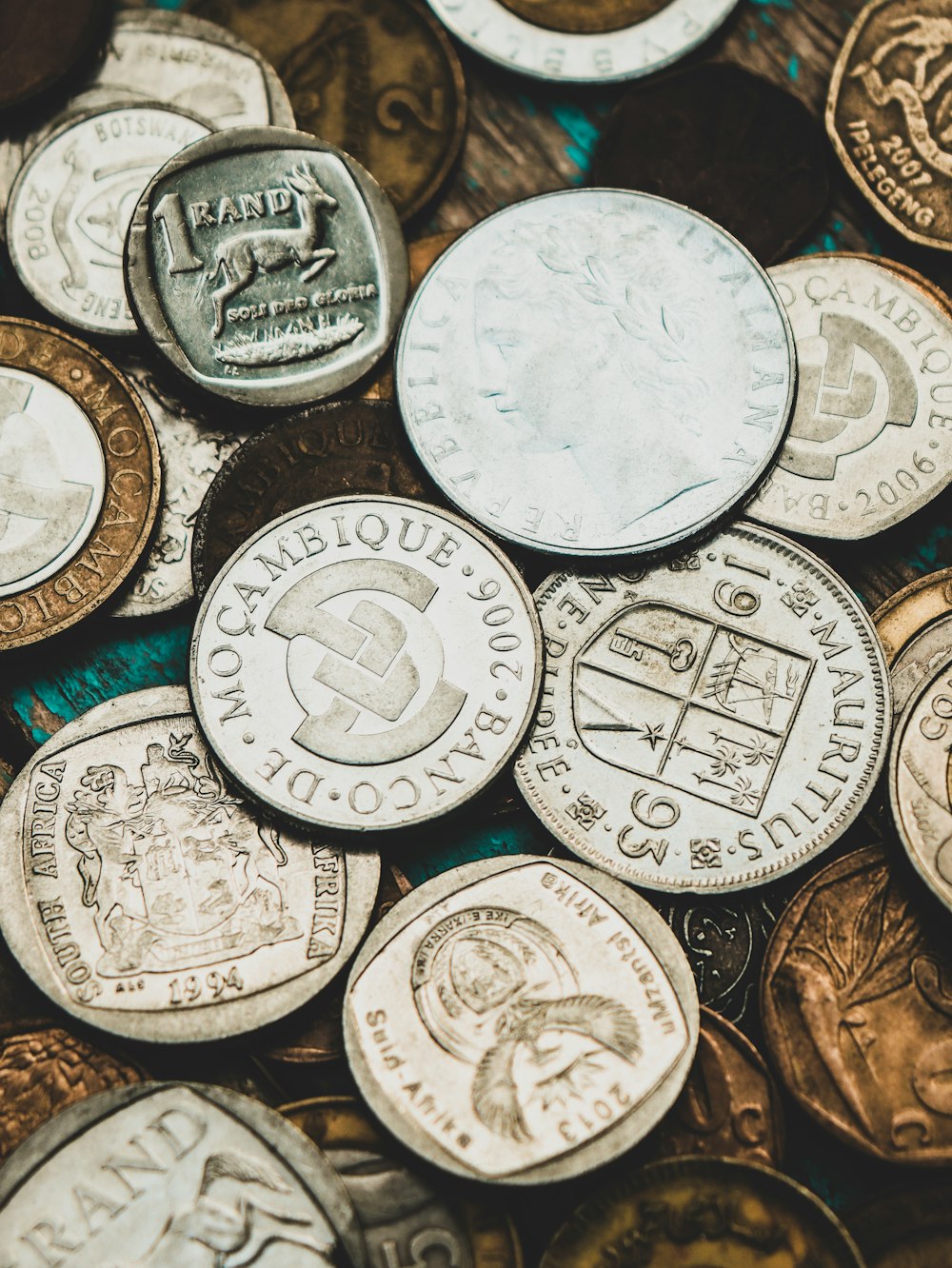 a pile of different types of coins