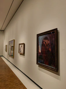 An elegant gallery wall showcasing original paintings with soft, neutral lighting.