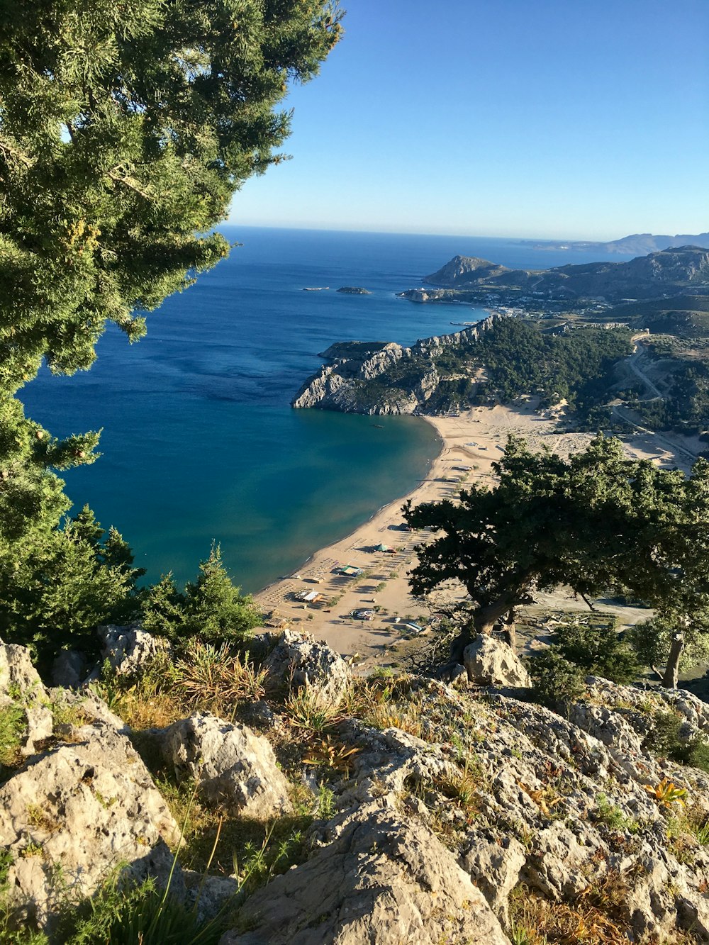 a view of a beach from the top of a hill