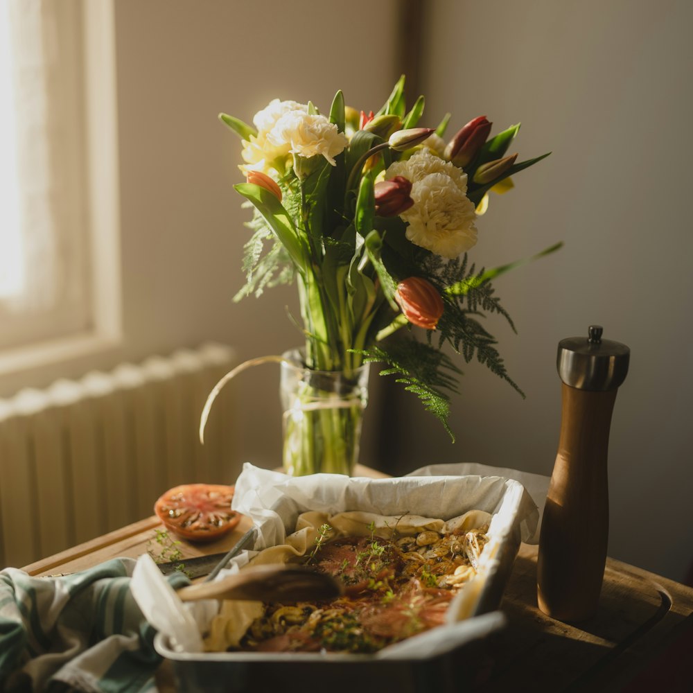 a vase of flowers sitting on top of a table