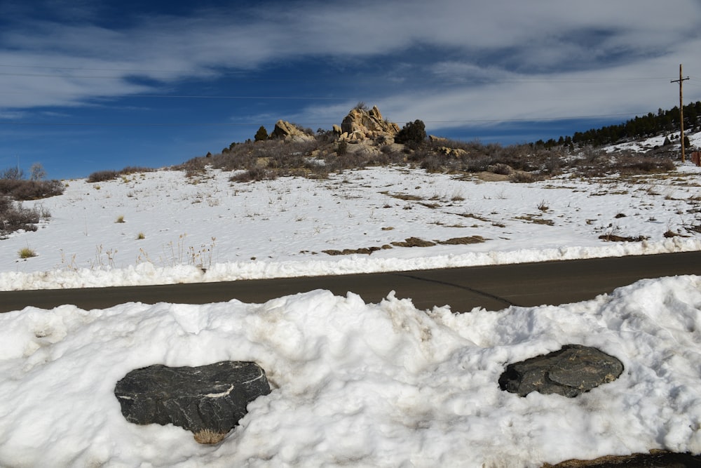 a couple of rocks sitting in the snow