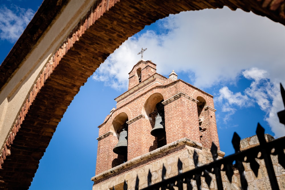 a tall tower with a cross on top of it