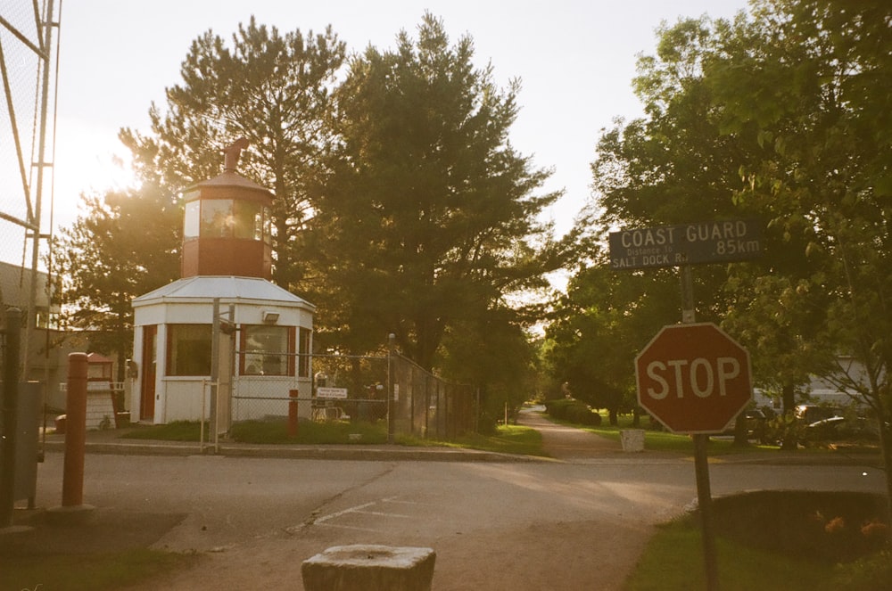 a red stop sign sitting next to a white building