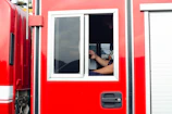 Close-up of a red and white truck cabin with black details.