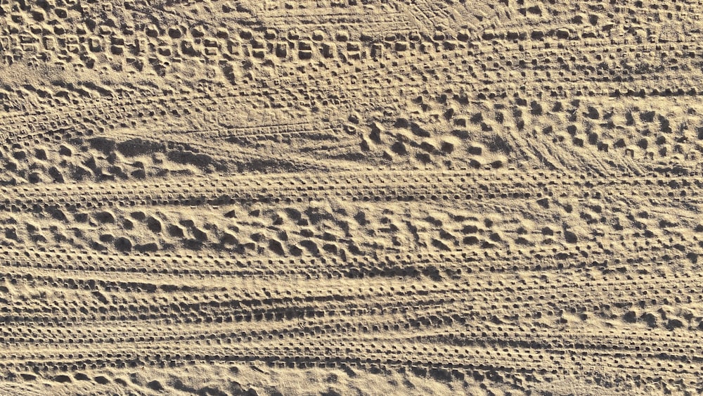 a close up of a sandy surface with traces of sand