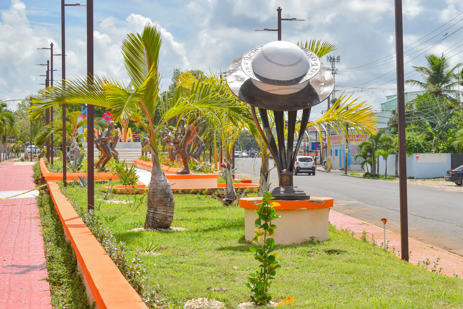 Palm-lined street with a clock tower in La Romana