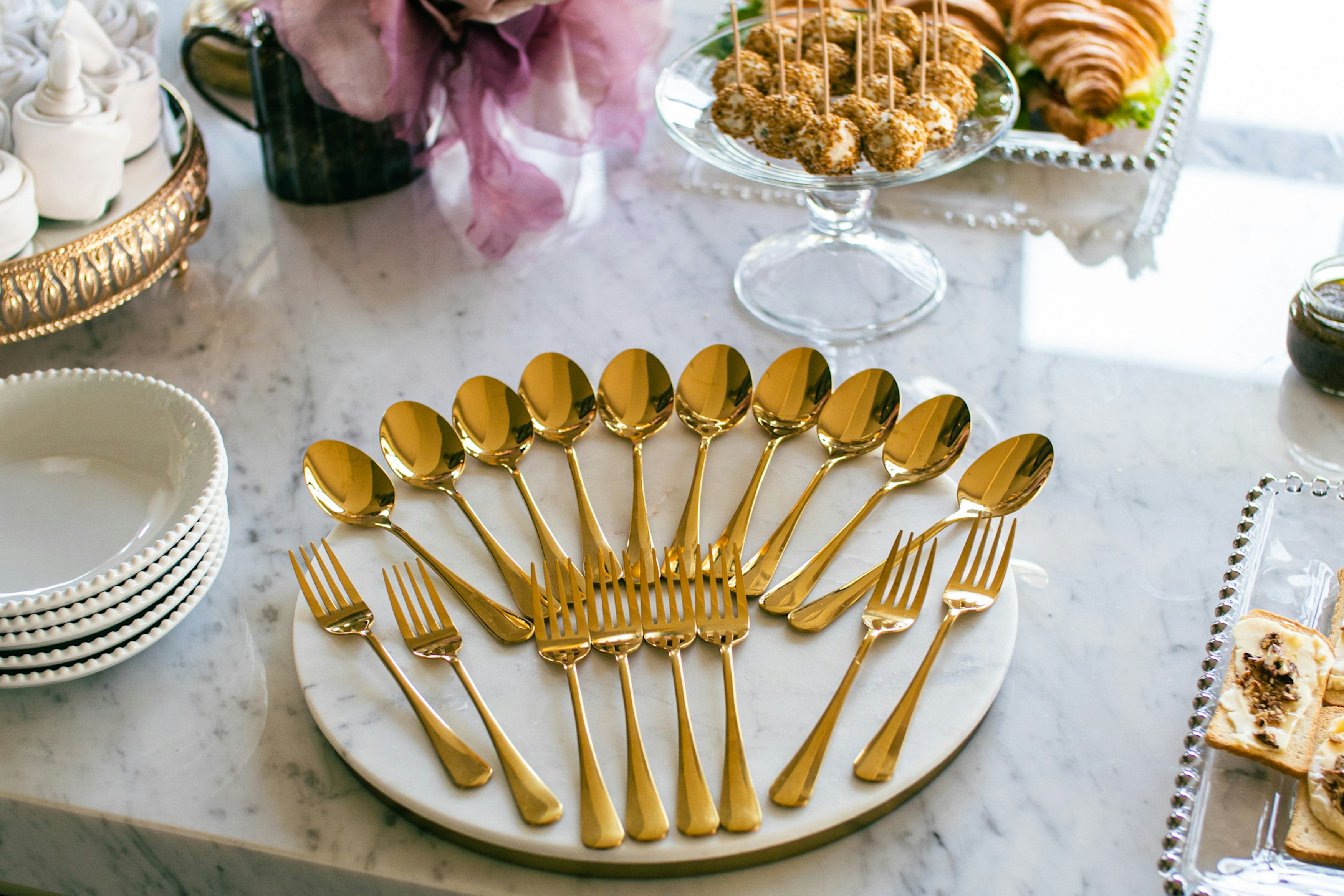 a table topped with lots of gold colored utensils