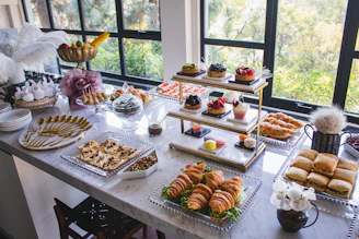 An inviting display of Saray Luxe sweets presented on a marble table with subtle golden accents