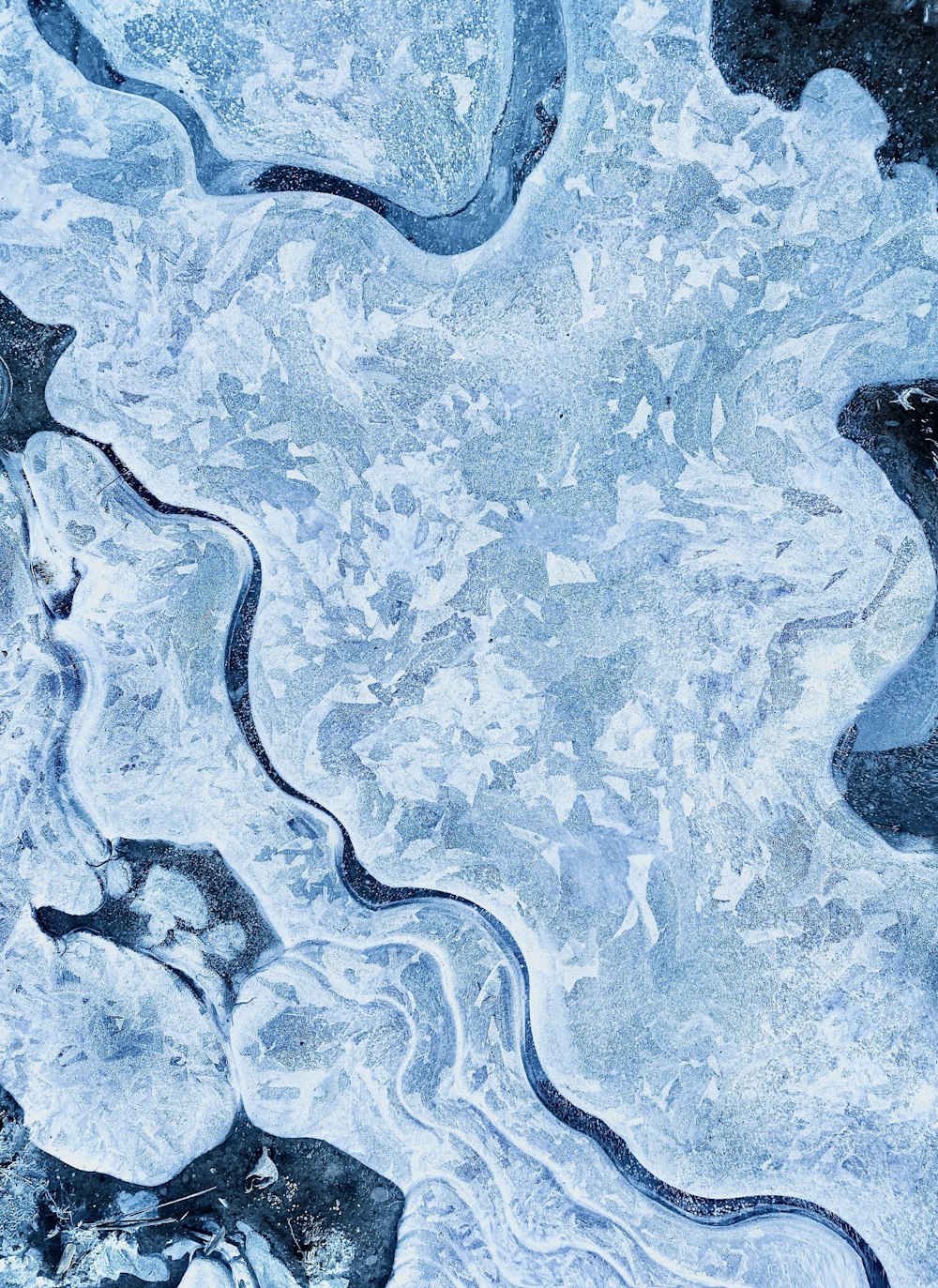 a close up of ice and water with a sky background