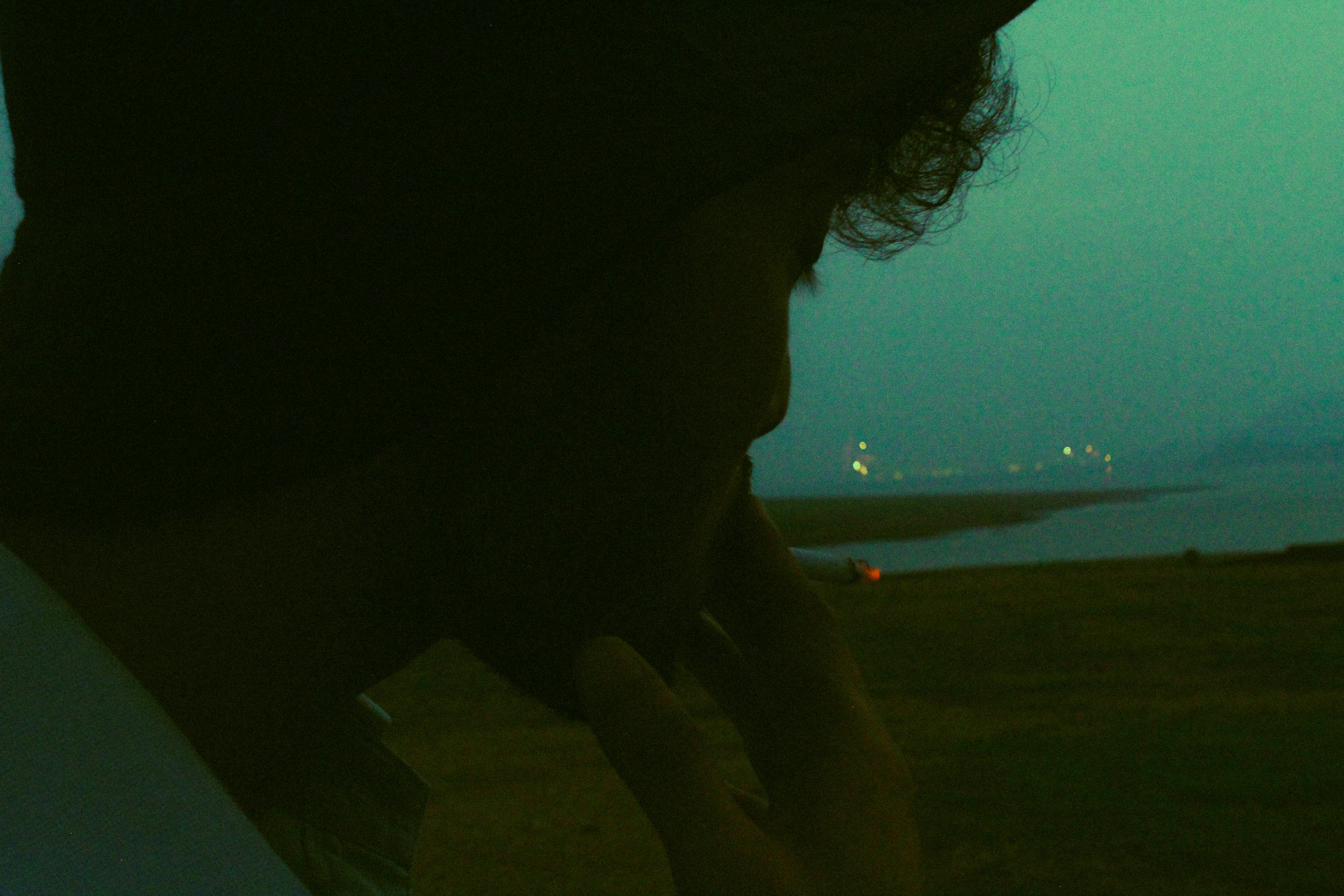 a man talking on a cell phone while standing in a field