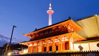 Exterior view of meme dôkounou at sunset, colorful lights glowing warmly.
