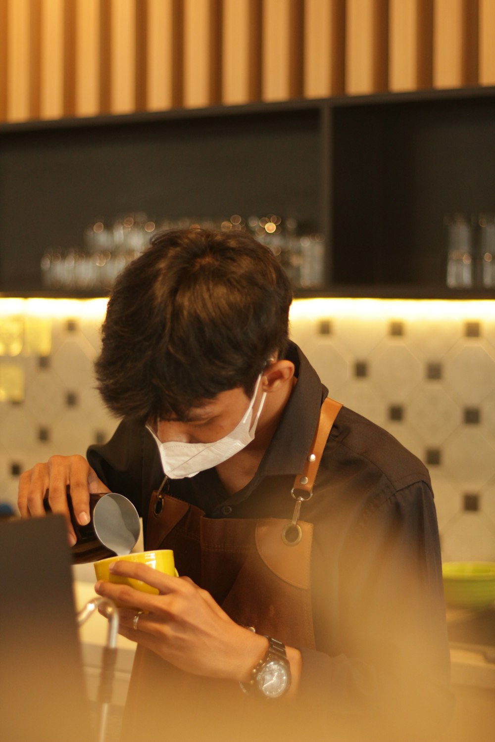 a man wearing a face mask while looking at his cell phone