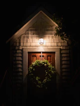 a wreath on the door of a house at night
