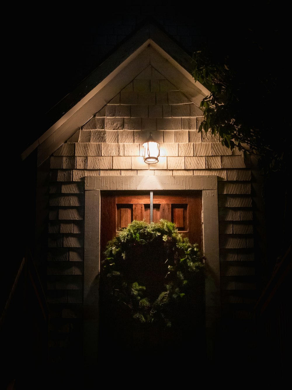 a wreath on the door of a house at night