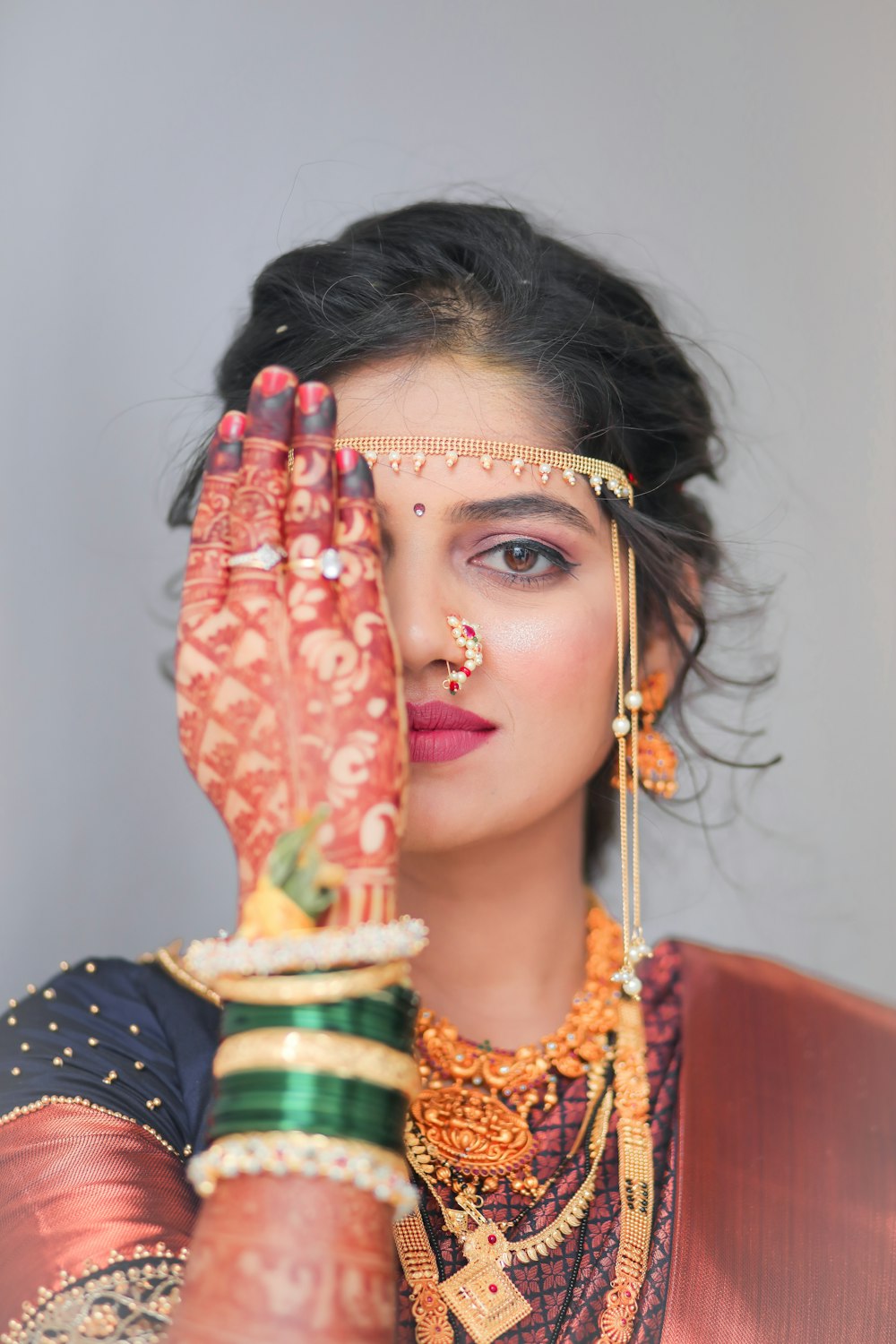 a woman holding her hands up to her face