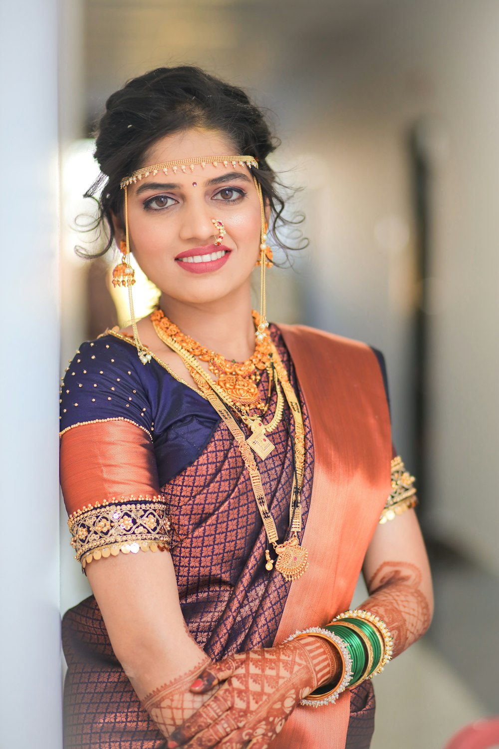 a woman in a sari and jewelry posing for a picture