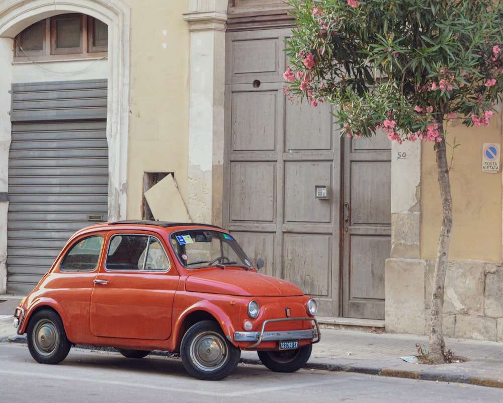 an orange car parked on the side of the road