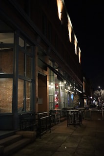 Nighttime exterior of a trendy Madrid restaurant reflecting subtle branding we designed on its windows.