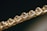 Close-up of a bracelet featuring a series of faceted, translucent stones or crystals, set in an intricately woven gold chain. The image focuses on the sparkle and clarity of the stones, giving a sense of luxury and elegance.