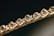 Close-up of a bracelet featuring a series of faceted, translucent stones or crystals, set in an intricately woven gold chain. The image focuses on the sparkle and clarity of the stones, giving a sense of luxury and elegance.