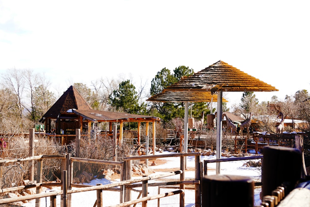 a wooden structure with a wooden roof in the snow