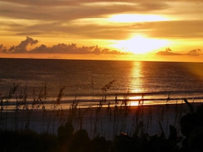 Sunset over the tranquil beaches of Gopalpur, Odisha, with golden skies reflecting on the water.