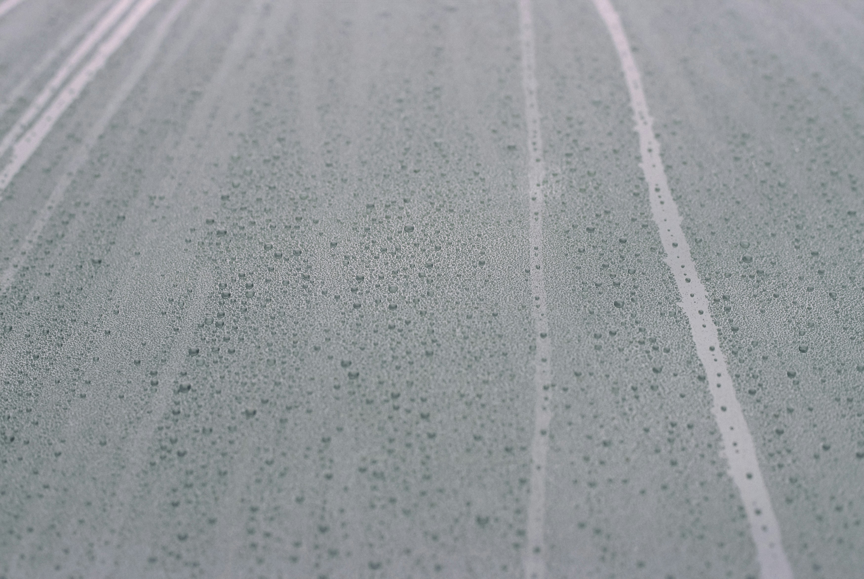 a car driving down a street next to a traffic light