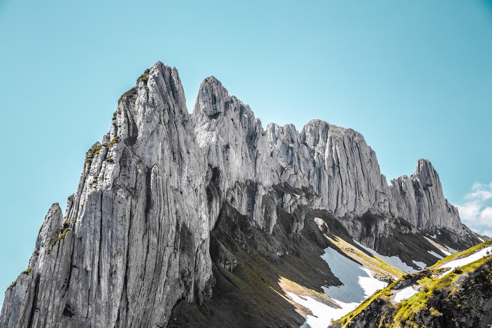 a very tall mountain with some snow on it