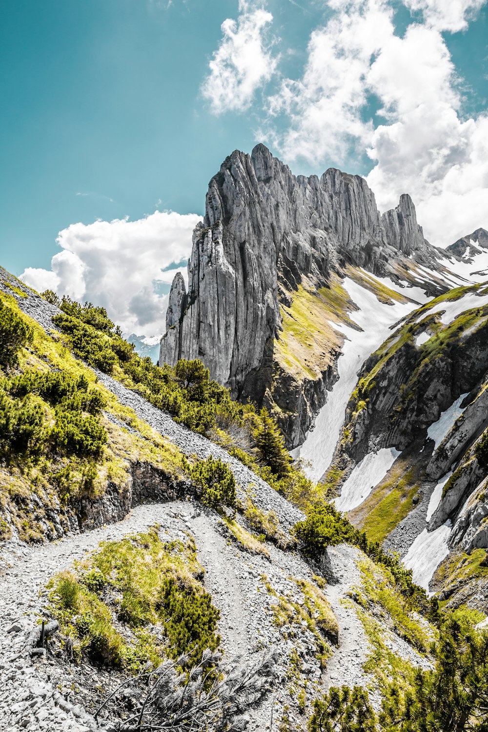 a rocky mountain with a trail going through it