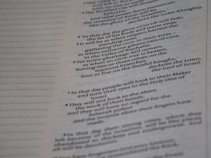 A close-up of a page from a book with text in a column layout. The text appears to be religious or biblical with references to 'the Lord Almighty' and 'God of Israel'. Dotted lines run alongside the text.