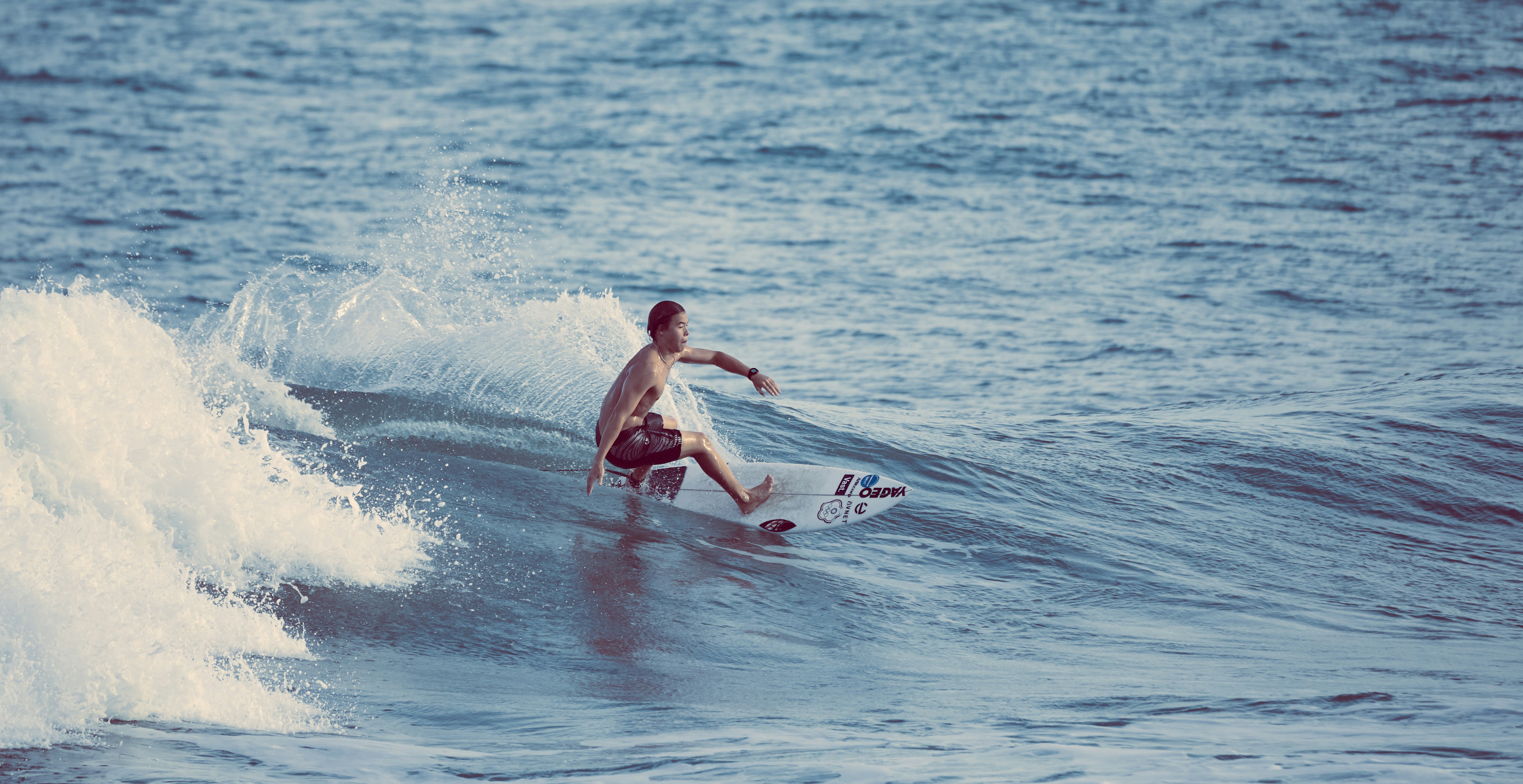 a man riding a wave on top of a surfboard